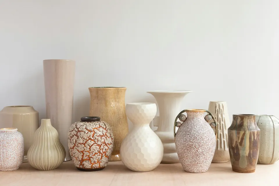 A shelf of vases in different glazes